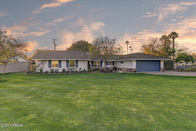 single story home with a lawn and a garage