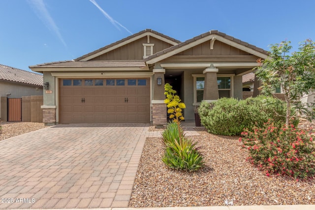 686 N 152nd Dr, Goodyear, AZ 85338 - craftsman house with board and batten siding, an attached garage, fence, and decorative driveway