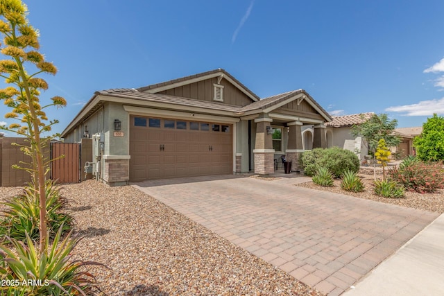 686 N 152nd Dr, Goodyear, AZ 85338 - ranch-style house featuring decorative driveway, fence, a tile roof, a gate, and a garage