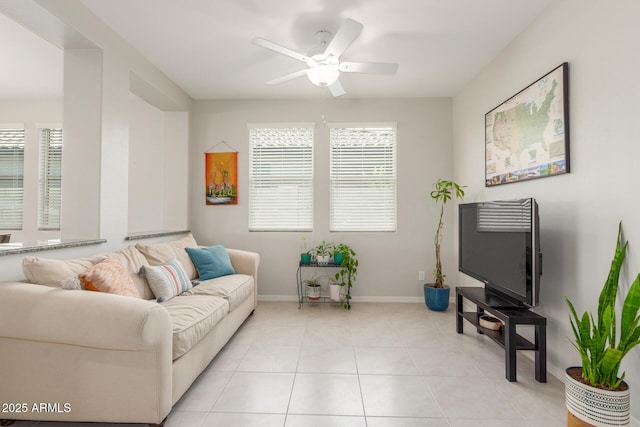 686 N 152nd Dr, Goodyear, AZ 85338 - living room featuring light tile patterned floors, baseboards, and a ceiling fan