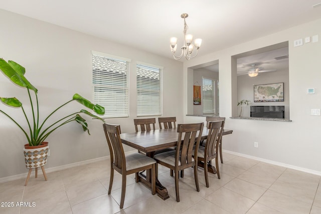 686 N 152nd Dr, Goodyear, AZ 85338 - dining area featuring ceiling fan with notable chandelier, light tile patterned floors, and baseboards