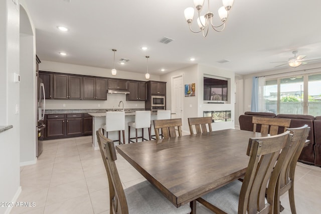 686 N 152nd Dr, Goodyear, AZ 85338 - dining area with visible vents, baseboards, light tile patterned floors, recessed lighting, and ceiling fan with notable chandelier