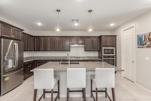 686 N 152nd Dr, Goodyear, AZ 85338 - kitchen featuring visible vents, a sink, appliances with stainless steel finishes, a kitchen breakfast bar, and dark brown cabinets
