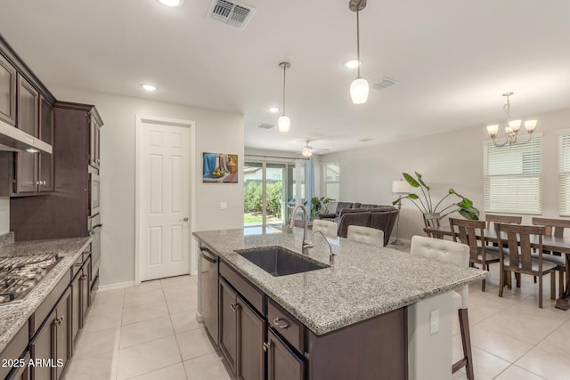 686 N 152nd Dr, Goodyear, AZ 85338 - kitchen with light tile patterned floors, visible vents, a sink, and dark brown cabinets