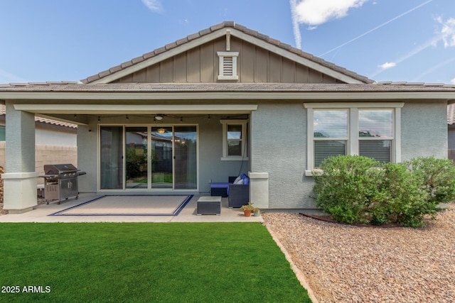 686 N 152nd Dr, Goodyear, AZ 85338 - back of property with a patio area, board and batten siding, and a lawn