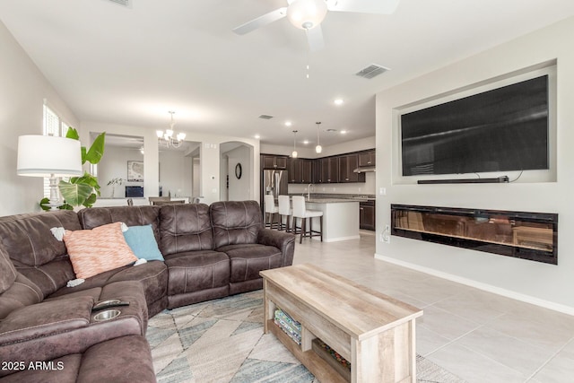 686 N 152nd Dr, Goodyear, AZ 85338 - living area with ceiling fan with notable chandelier, light tile patterned floors, visible vents, recessed lighting, and baseboards