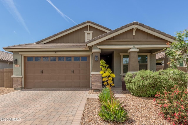 686 N 152nd Dr, Goodyear, AZ 85338 - craftsman inspired home with board and batten siding, a garage, a tile roof, and decorative driveway