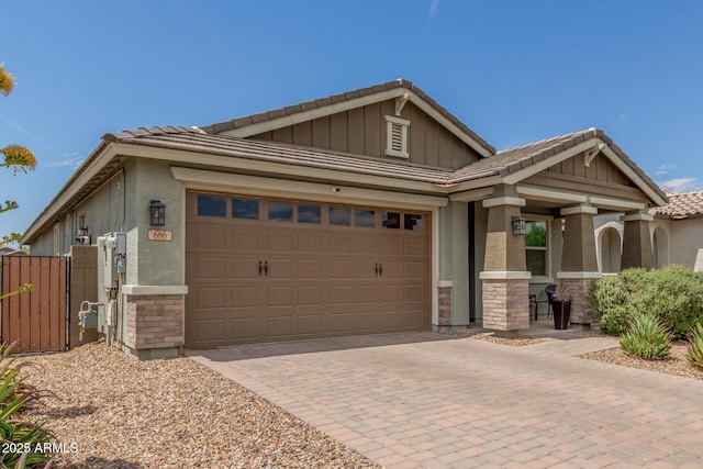 686 N 152nd Dr, Goodyear, AZ 85338 - view of front facade with stucco siding, stone siding, decorative driveway, a tile roof, and a garage
