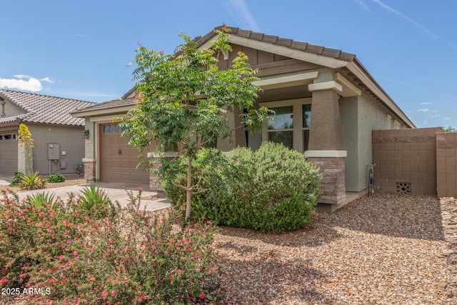 686 N 152nd Dr, Goodyear, AZ 85338 - view of front of home with an attached garage, driveway, stucco siding, and fence