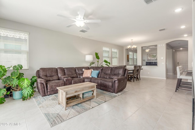 686 N 152nd Dr, Goodyear, AZ 85338 - living area with visible vents, arched walkways, light tile patterned flooring, and ceiling fan with notable chandelier