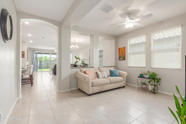 686 N 152nd Dr, Goodyear, AZ 85338 - living room featuring light tile patterned floors, visible vents, ceiling fan with notable chandelier, and baseboards