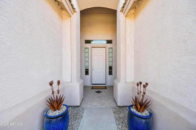 view of exterior entry with stucco siding