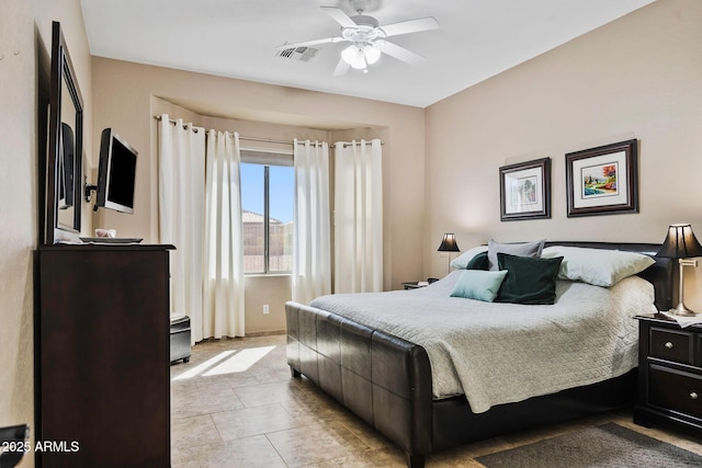 bedroom with light tile patterned floors, a ceiling fan, and visible vents