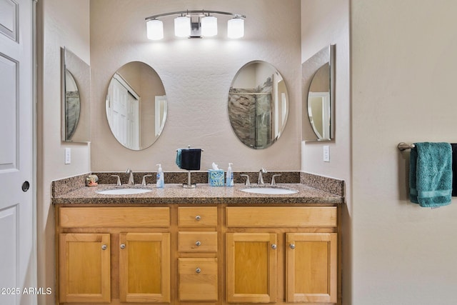 full bathroom with a sink, a shower, and double vanity