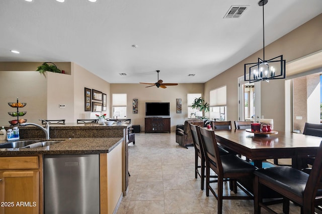 dining space featuring a wealth of natural light, visible vents, ceiling fan with notable chandelier, and light tile patterned floors