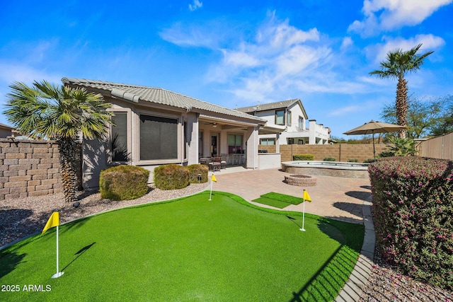 back of property featuring a ceiling fan, a patio, a tiled roof, and a fenced backyard