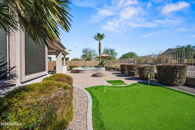 view of yard featuring a patio, a fenced backyard, and a hot tub