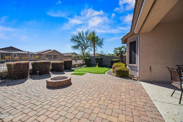 view of patio / terrace with a fenced backyard and an outdoor fire pit