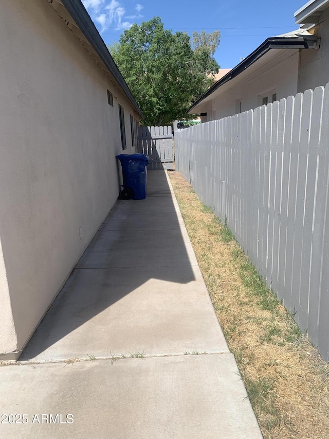 view of home's exterior with fence and stucco siding
