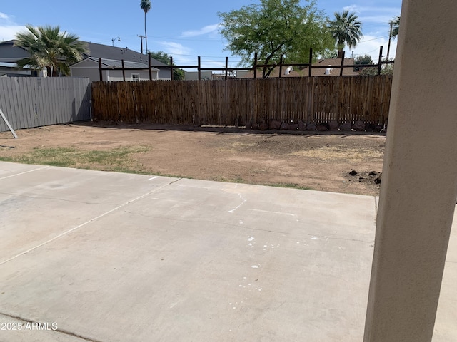 view of yard featuring a patio and fence
