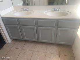 bathroom with double vanity, tile patterned floors, and a sink