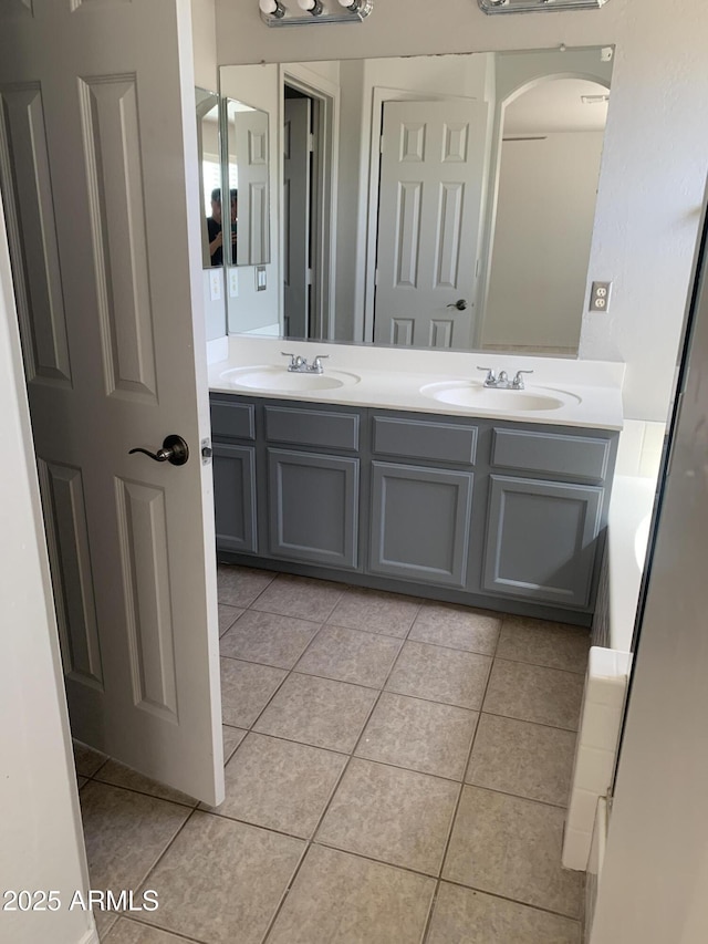 bathroom with double vanity, tile patterned floors, and a sink