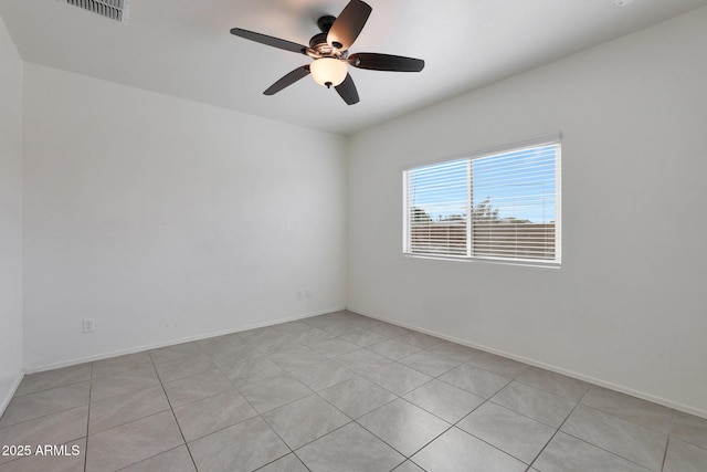 unfurnished room with ceiling fan and light tile patterned floors