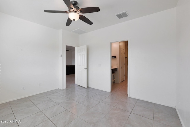 spare room featuring ceiling fan and light tile patterned floors