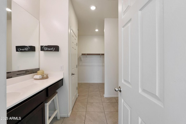 bathroom with tile patterned floors, tasteful backsplash, and vanity