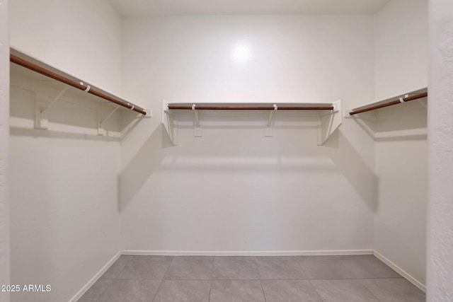 walk in closet featuring light tile patterned floors