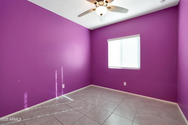 empty room with tile patterned floors and ceiling fan