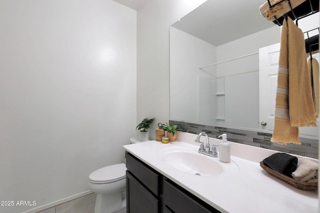 bathroom with vanity, a shower, backsplash, and toilet