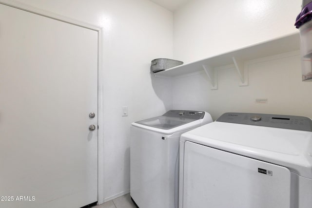 washroom with light tile patterned flooring and separate washer and dryer