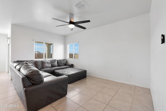 living room with ceiling fan and light tile patterned flooring