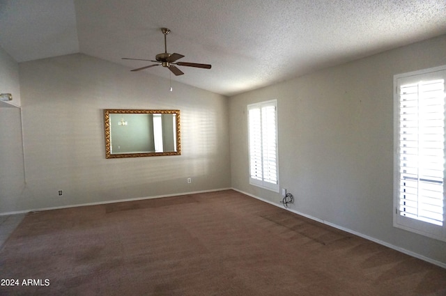 carpeted empty room with ceiling fan, a textured ceiling, and vaulted ceiling