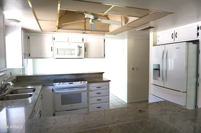 kitchen with white cabinets, white appliances, sink, and light tile patterned floors