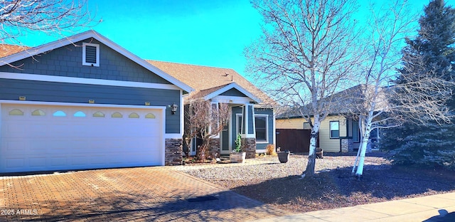 view of front of property featuring a garage and decorative driveway