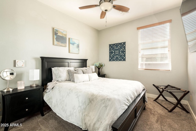 bedroom with a ceiling fan, baseboards, and dark colored carpet