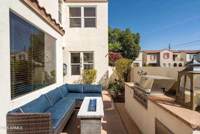 view of patio featuring area for grilling, fence, a residential view, an outdoor living space with a fire pit, and a grill