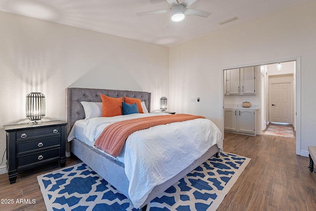 bedroom with dark hardwood / wood-style floors and ceiling fan