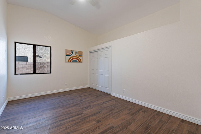 unfurnished room with vaulted ceiling, dark hardwood / wood-style floors, and ceiling fan