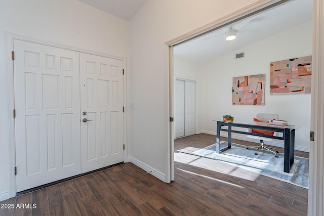 foyer featuring dark hardwood / wood-style flooring and vaulted ceiling