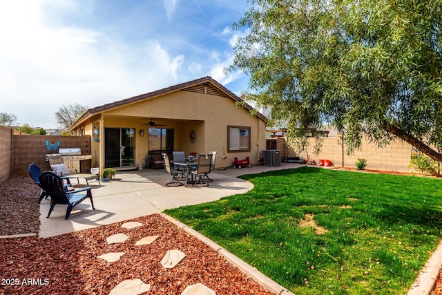 back of property featuring central AC unit, a ceiling fan, a patio, a fenced backyard, and stucco siding