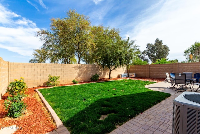 view of yard featuring a patio area, central AC, and a fenced backyard