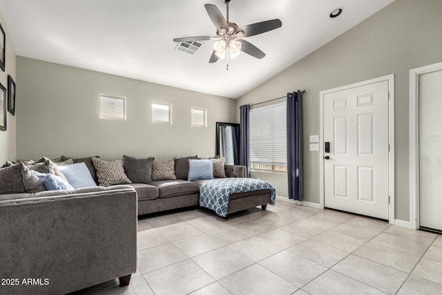 living room with light tile patterned floors, visible vents, vaulted ceiling, and a ceiling fan