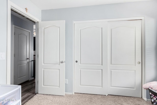 bedroom with light carpet and a closet