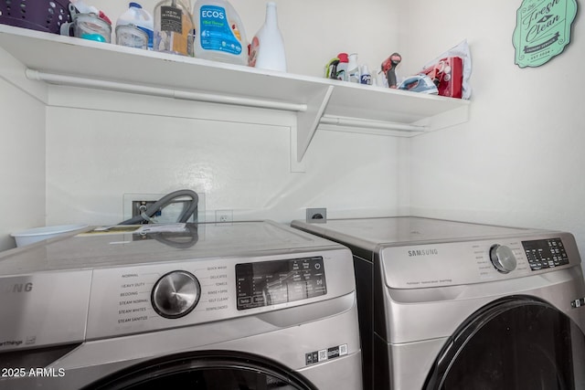 laundry room with washer and dryer and laundry area