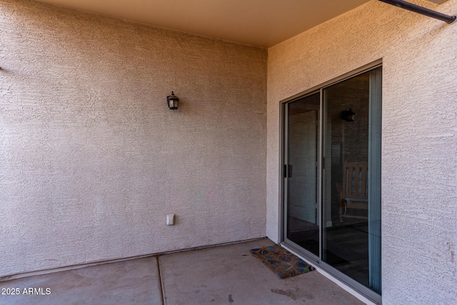 doorway to property with stucco siding