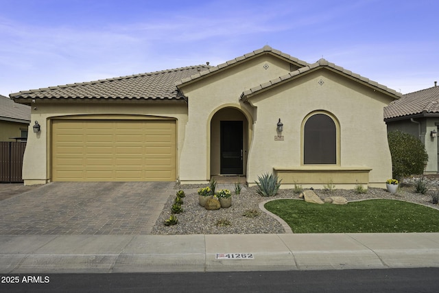 mediterranean / spanish-style house with a garage