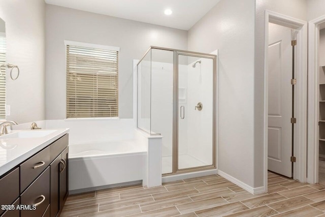 bathroom with shower with separate bathtub and vanity